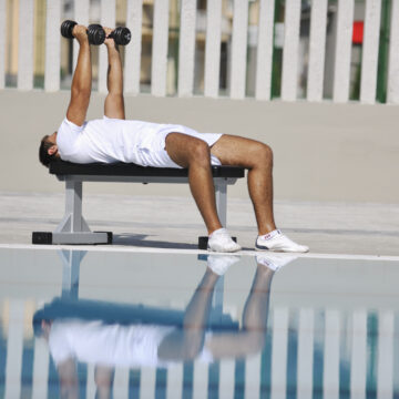 young man exercise at poolside Personal trainings